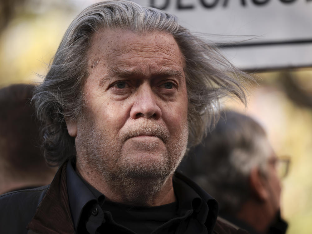 Former Trump administration White House adviser Steve Bannon listens as attorney David Schoen speaks to reporters outside of the E. Barrett Prettyman Federal District Court House on Nov. 15, 2021.