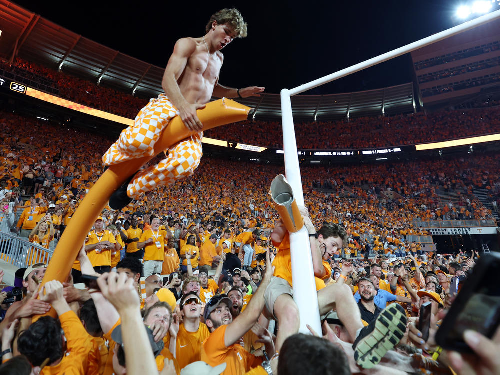Tennessee Volunteers fans tear down a goal post after their team defeated the Alabama Crimson Tide at Neyland Stadium. The school is facing a large fine — and it wants help paying for new goal posts.