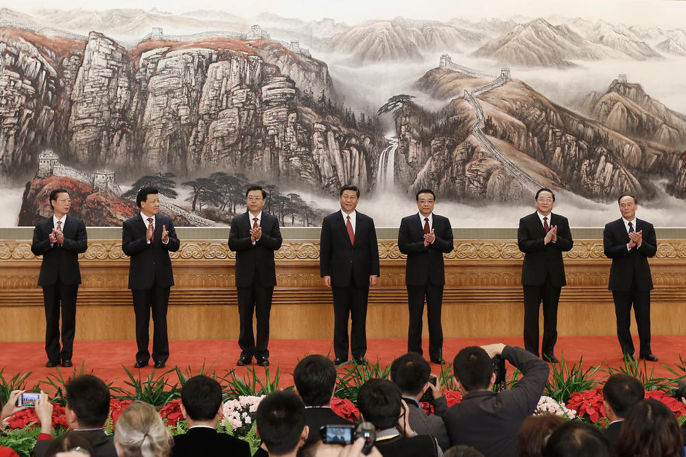 Xi Jinping (center) greets the media at the Great Hall of the People on Nov. 15, 2012, in Beijing. China's Communist Party revealed the new Politburo Standing Committee after its 18th congress. At this week's 20th congress, Xi is expected to be granted another term as head of the party and military.