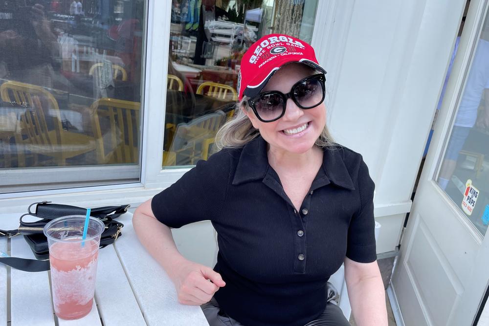 Krista Wagner is sipping a frozen wine, watching a University of Georgia football game in Alpharetta, Ga. on Sept. 17. Wagner voted for Trump in 2016 and then Biden in 2020 but her flip to the Democrats that year wasn't permanent.