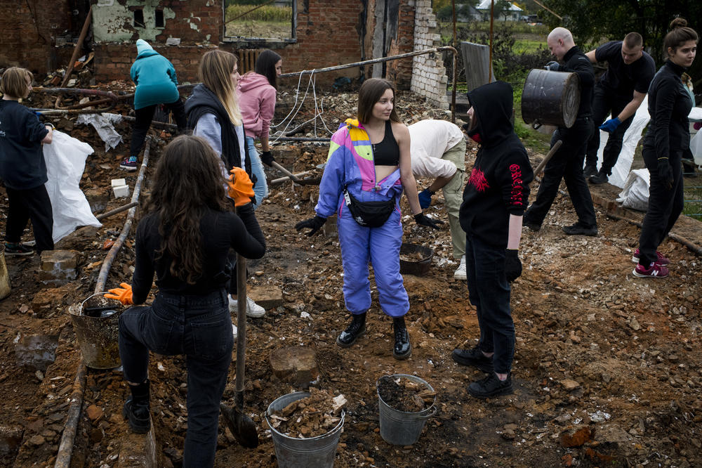 Repair Together volunteers clean up the home of Hanna Yurchenko in Kolychivka, Ukraine.