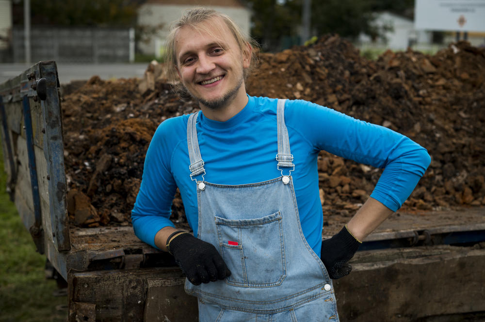 Roman Tarasiuk, 27, helps clean up the destroyed home of Hanna Yurchenko in Kolychivka on Oct. 1.