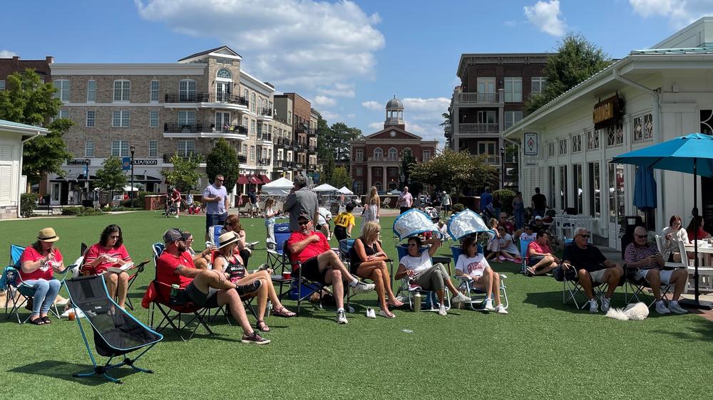 Residents relax on the town green in Alpharetta, Ga., an upscale city just outside Atlanta on Sept. 17, 2022.