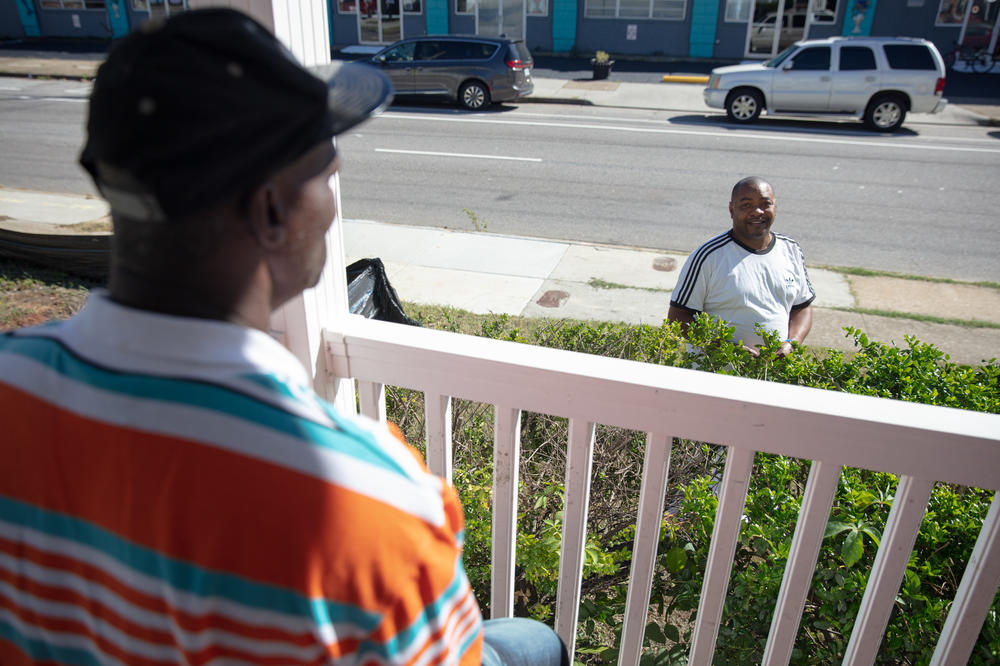 Eric Perkins (right) says he lived on the beach, then a shelter and then in a hotel during the pandemic before moving into the Norfolk apartment. The median local rent for a one-bedroom apartment is over $1,000. Perkins' rent is $600.