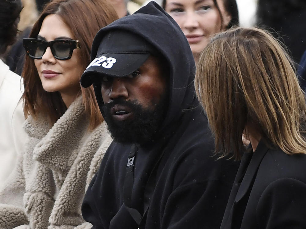 Ye (C), formerly known as Kanye West, attends the Givenchy Spring-Summer 2023 fashion show during the Paris Womenswear Fashion Week, in Paris, on Oct. 2, 2022.