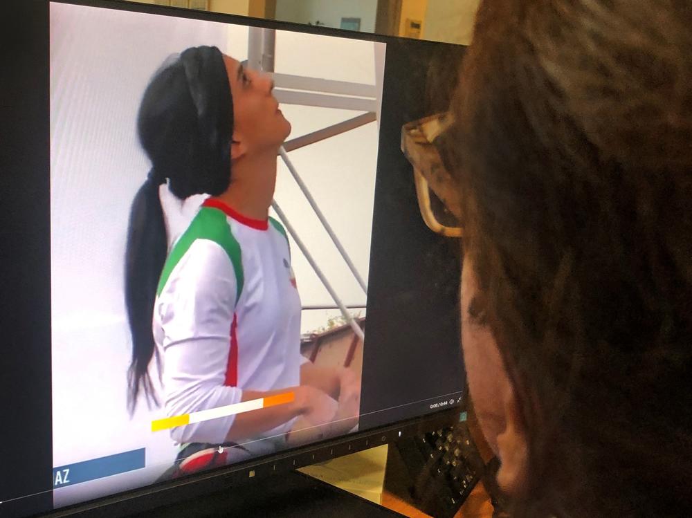 A woman in the Cypriot capital of Nicosia watches a video of Iranian climber Elnaz Rekabi competing without a hijab at an international climbing competition in Seoul, South Korea.