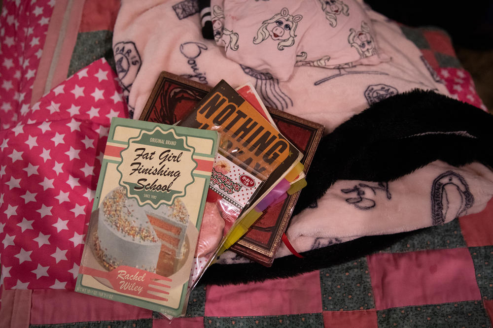 Books by poet Rachel Wiley lay scattered on a bed in Camp Roundup's bunks on Labor Day weekend.