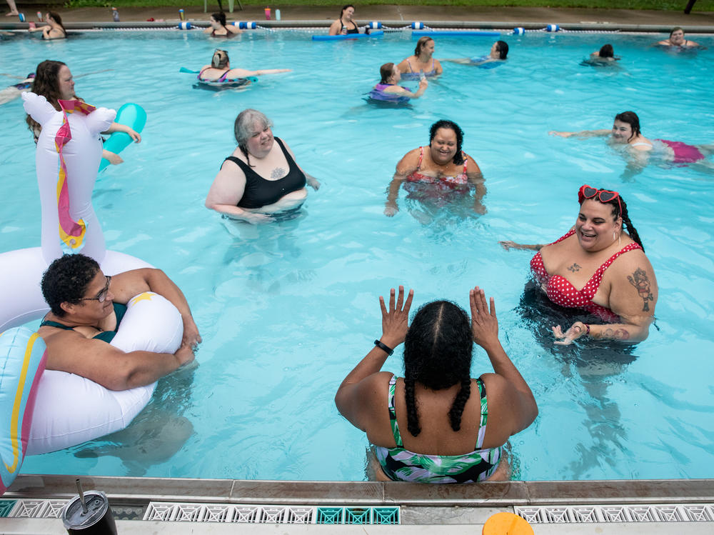 Women hang out in the pool and listen to Teri Collins tell them a story at Camp Roundup, a body positivity and acceptance camp for women that took place Labor Day weekend in Newark, Ohio.