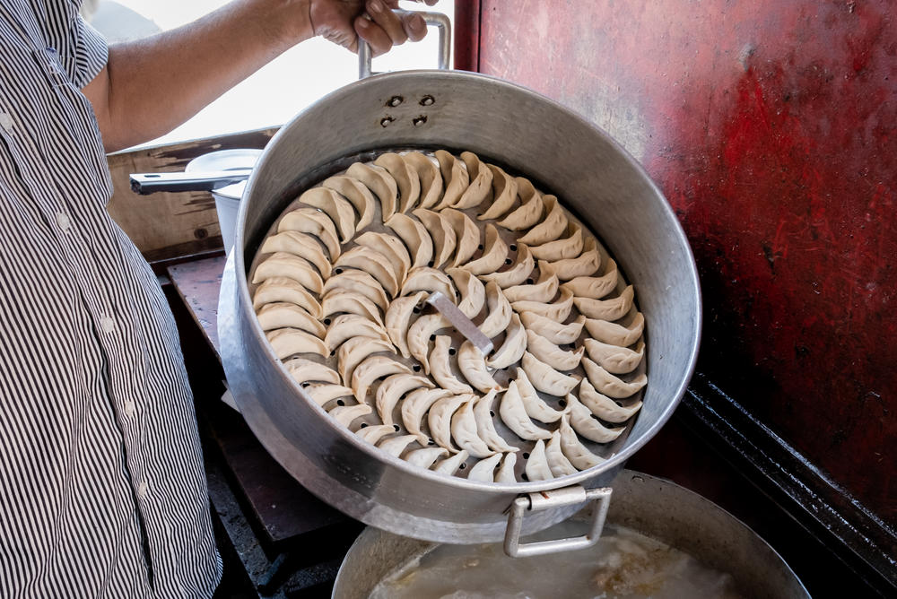 <em>Momos</em> are steamed or fried dough stuffed with minced meat or vegetables, often with hot sauce. Bhat says he cooks them for hundreds of daily customers at his restaurant: 