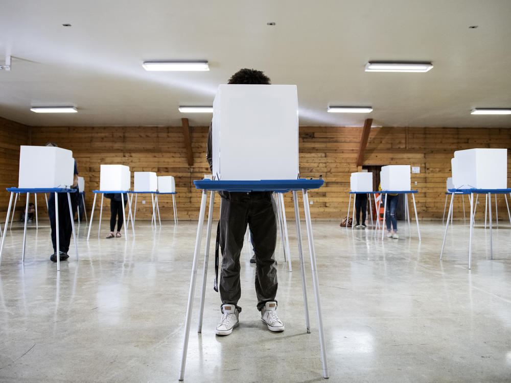 Voters fill out their ballots at the Gallatin County Fairgrounds in Bozeman, Mont., on Nov. 3, 2020.
