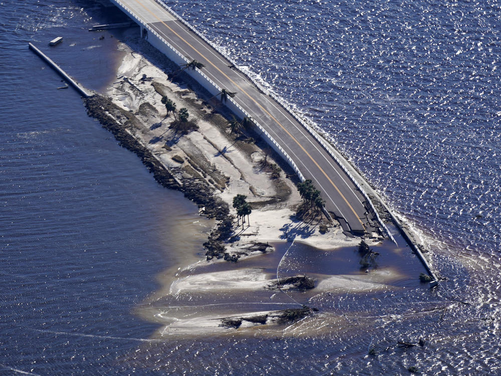 In this aerial photo made in a flight provided by mediccorps.org, damage from Hurricane Ian is seen on the causeway leading to Sanibel Island from Fort Myers, Fla., on Sept. 30. The causeway has reopened with temporary repairs.