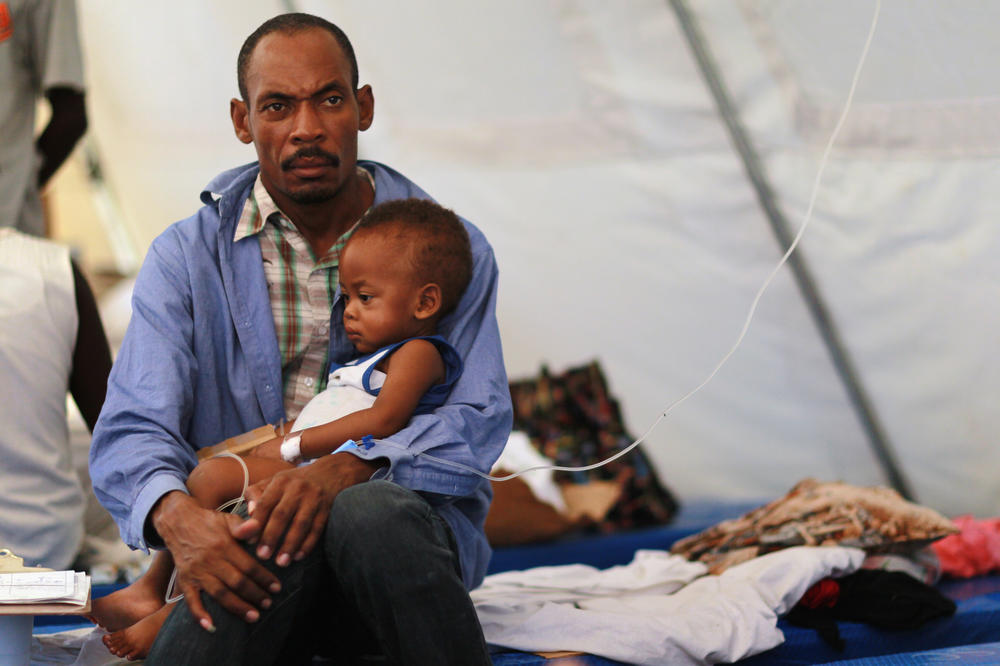 Theophil Gilot holds his son, Alexendro Gilot, who is treated for cholera in a facility in Cabaret, Haiti, on Nov. 24, 2010. In December 2016, then-U.N. Secretary-General Ban Ki-moon apologized for the U.N.'s role in a cholera outbreak, saying peacekeepers were the most likely source.