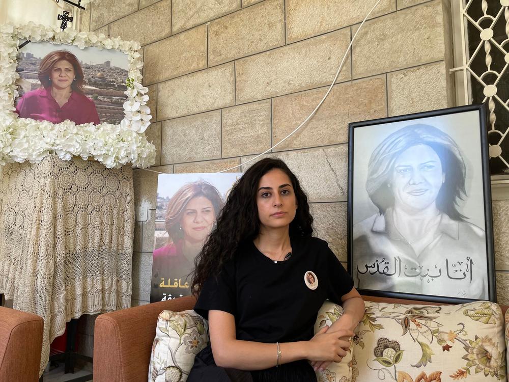 Lina Abu Akleh sits near photographs of her late aunt, journalist Shireen Abu Akleh, at their family home in east Jerusalem in July.