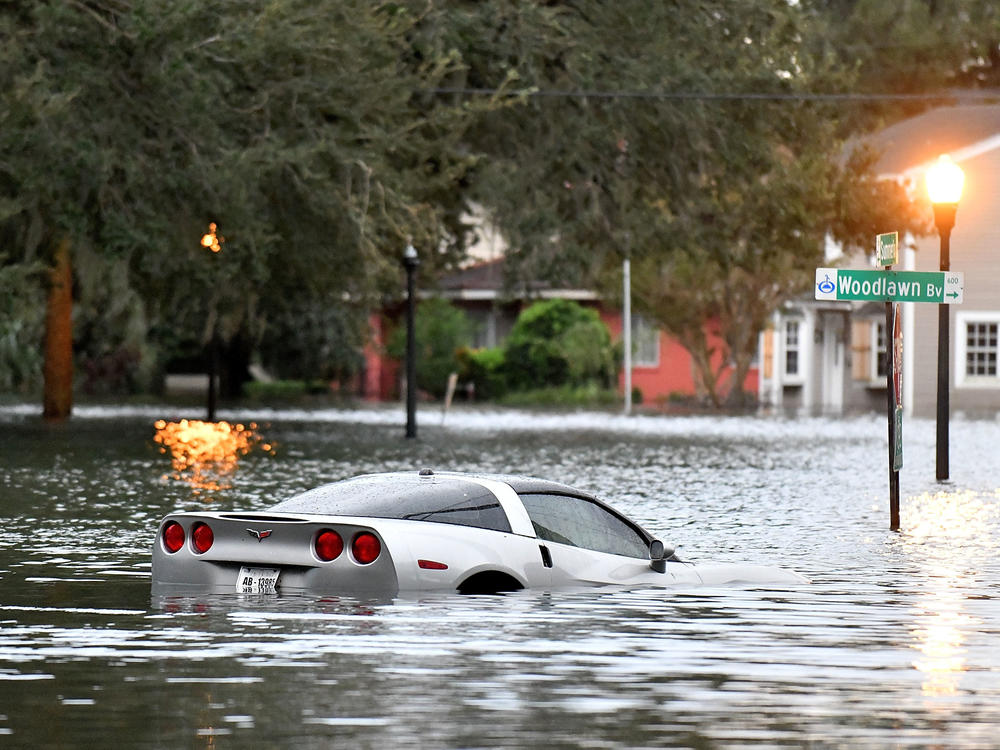 A car sits in floodwater after Hurricane Ian in Orlando. Those who come into contact with floodwaters should immediately wash all wounds.