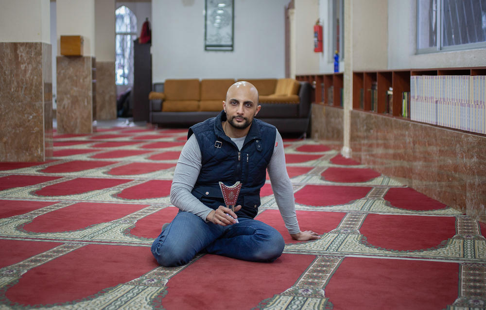 Nader Alareqi, originally from Sanaa, Yemen, holds the incense stones known as <em>bakhoor</em> that his grandmother made for him, using her special mix of perfumes and herbs. He was photographed at the Khalid Ibnel-Waleed Mosque in Quito, Ecuador, where he has lived since 2016.