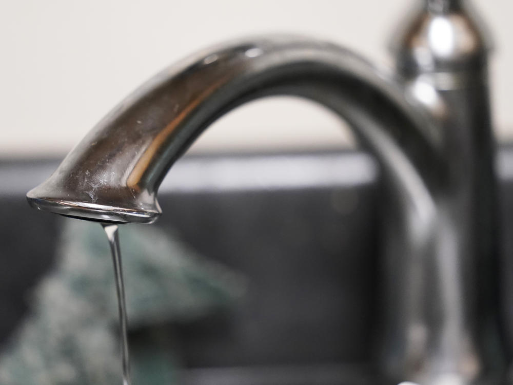 A trickle of water comes out of the faucet of Mary Gaines a resident of the Golden Keys Senior Living apartments in her kitchen in Jackson, Miss., Sept. 1, 2022.