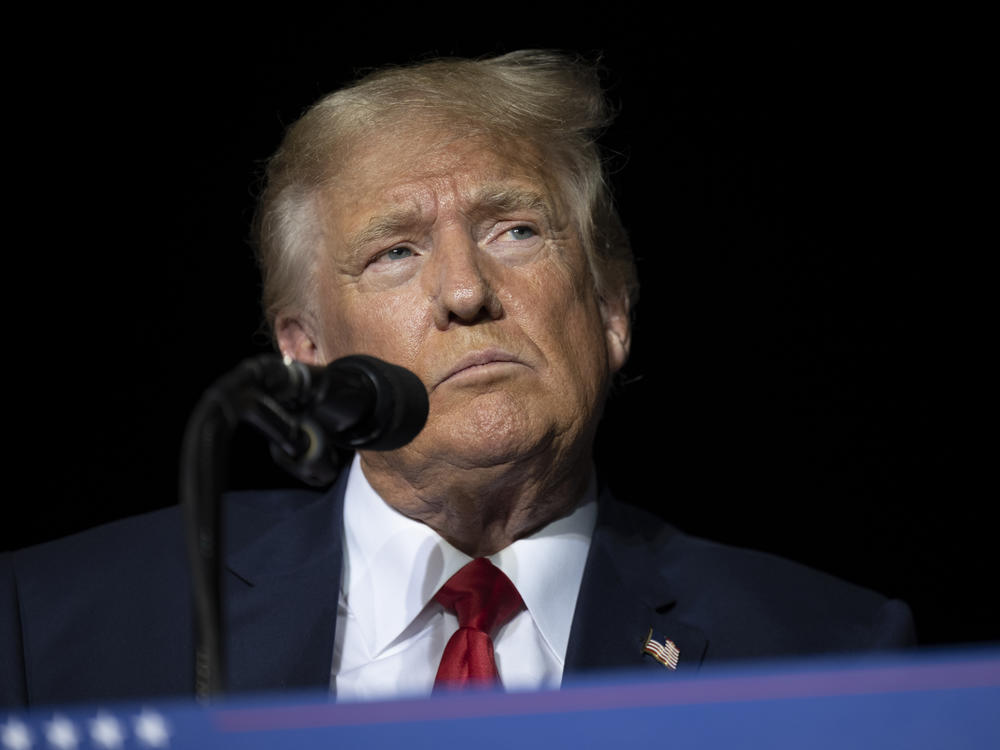 Former President Donald Trump pauses while speaking at a rally at the Minden Tahoe Airport in Minden, Nev., on Oct. 8, 2022.