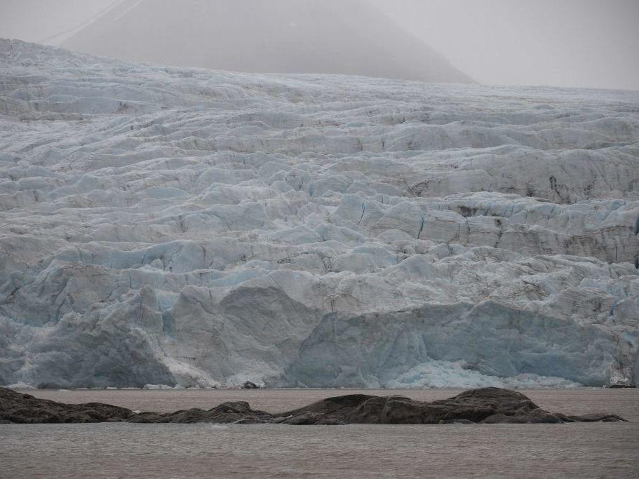 A view of Nordenskiold glacier melting and collapsing in the ocean in September 2021 in  Svalbard, a northern Norwegian archipelago.