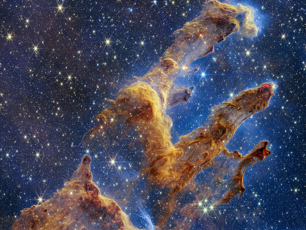 The Pillars of Creation as captured by NASA's James Webb Space Telescope look like arches and spires and are filled with semi-transparent gas and dust. This is a region where young stars are forming.