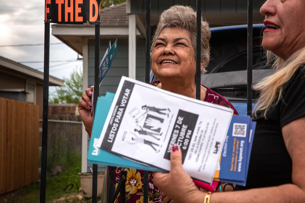 Flora Martinez Duran speaks to a member of LUPE as they canvass in San Juan, Texas, on. Oct. 4.