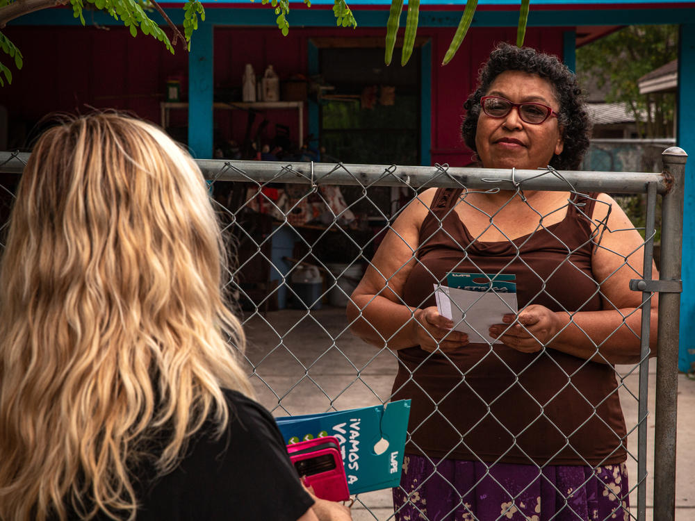 Yesenia Monisvais speaks to a member of LUPE as they canvass in San Juan, Texas, on Oct. 4.