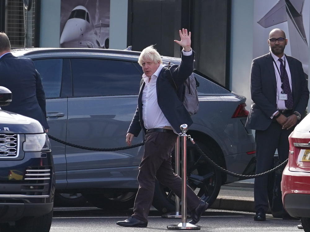 Former Prime Minister Boris Johnson arrives at Gatwick Airport in London on Saturday, after travelling on a flight from the Caribbean following the resignation of Liz Truss as prime minister.