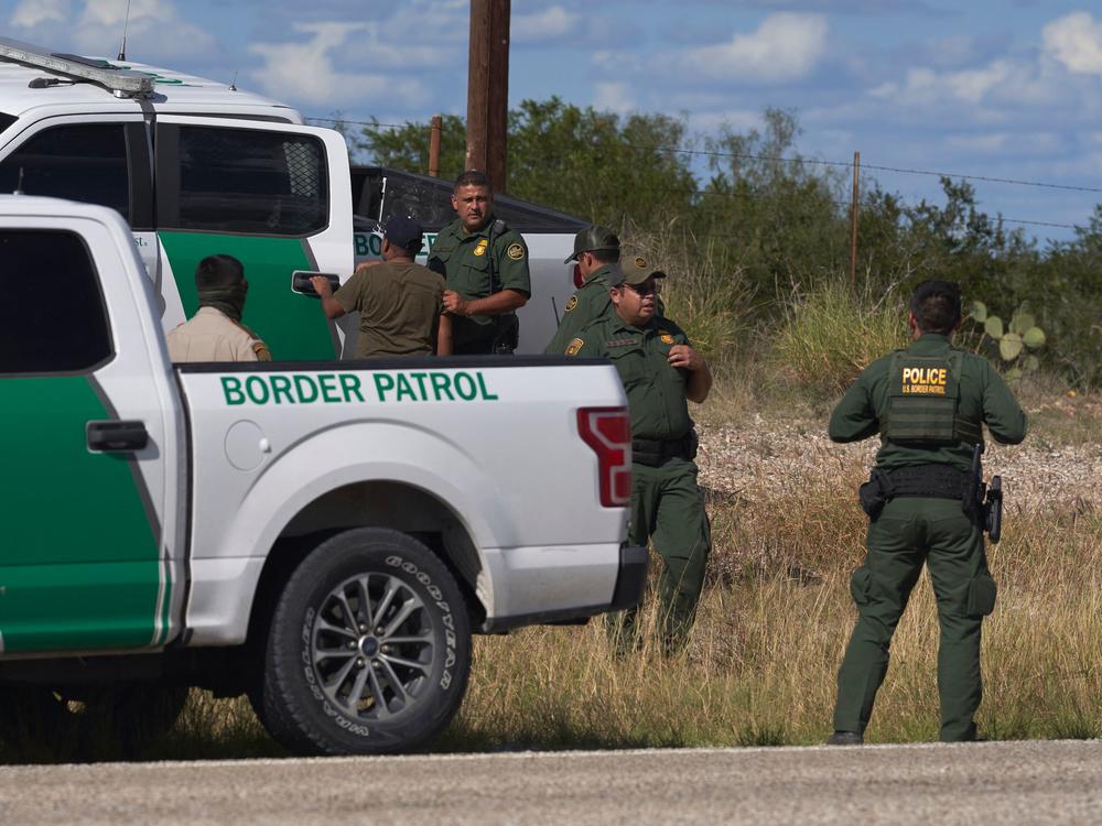 A migrant found smuggled in a vehicle is apprehended by U.S. Border Patrol and the Webb County Sheriff on Oct. 12 in Laredo, Texas.