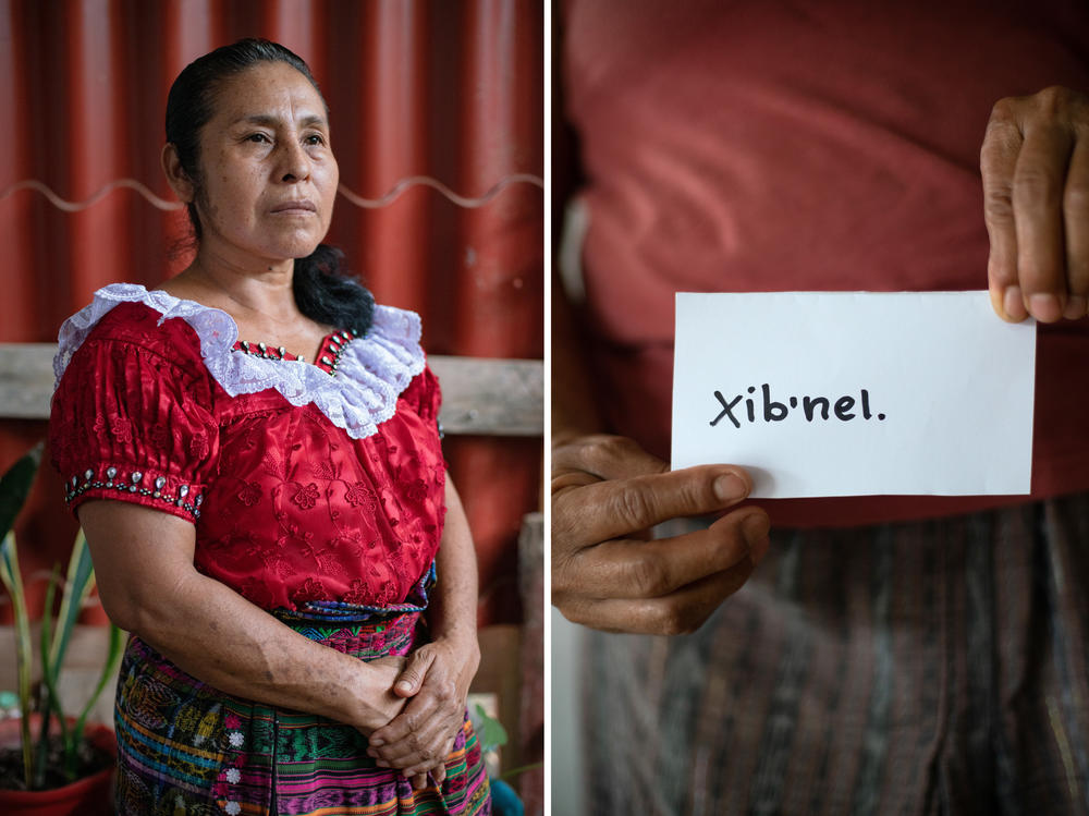 Rosa Gonzalez, born in Guatemala, holds a sign with the word 