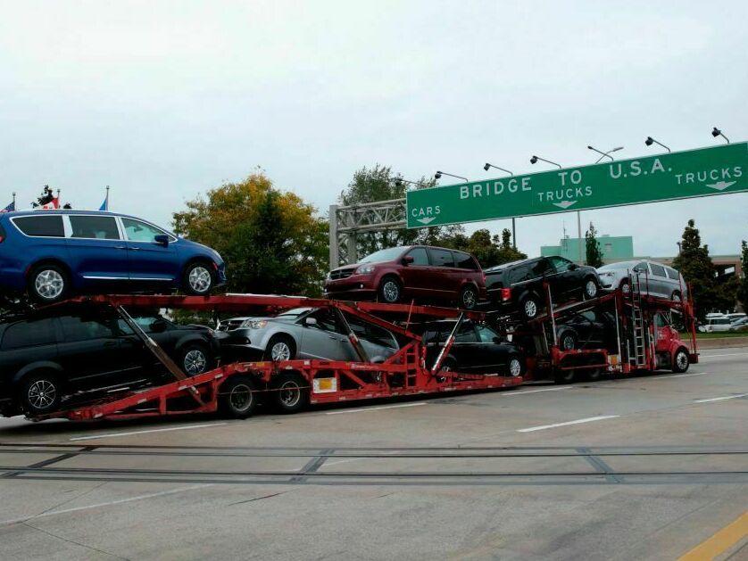 A car hauler carrying Chrysler Pacificas' approaches the Ambassador Bridge that connects Windsor, Canada, to Detroit, Michigan,on October 5, 2018 in Windsor, Ontario, Canada.