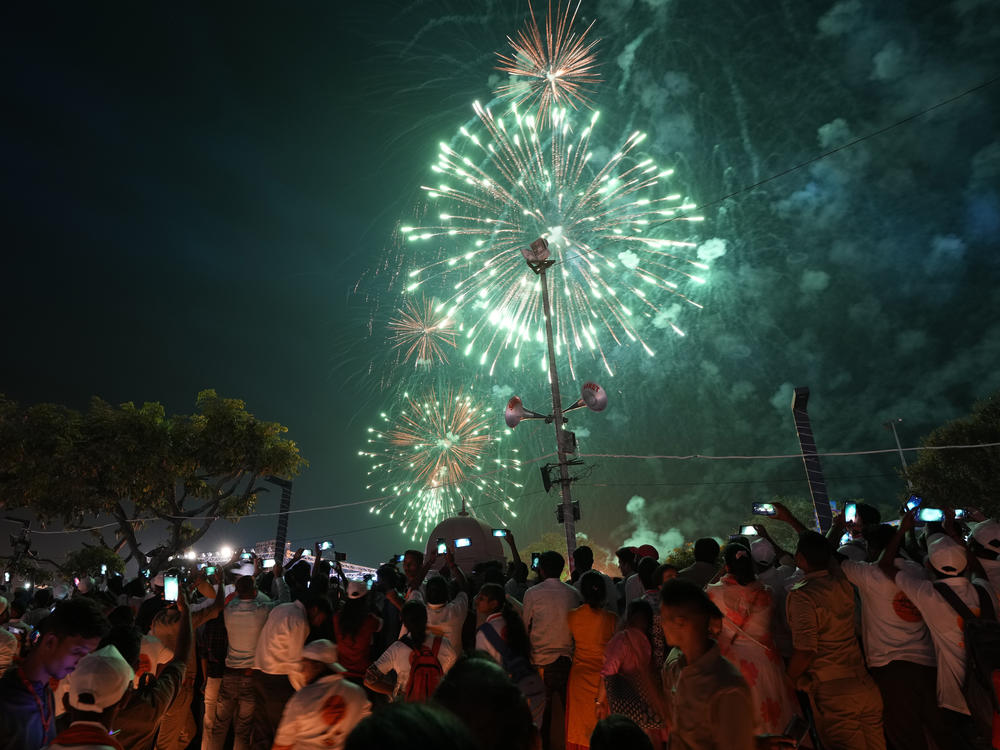Firecrackers light up the sky over lamps lined on the banks of the river Saryu in Ayodhya, India, Sunday , Oct. 23, 2022. Hindus believe the city is the birthplace of Ram.