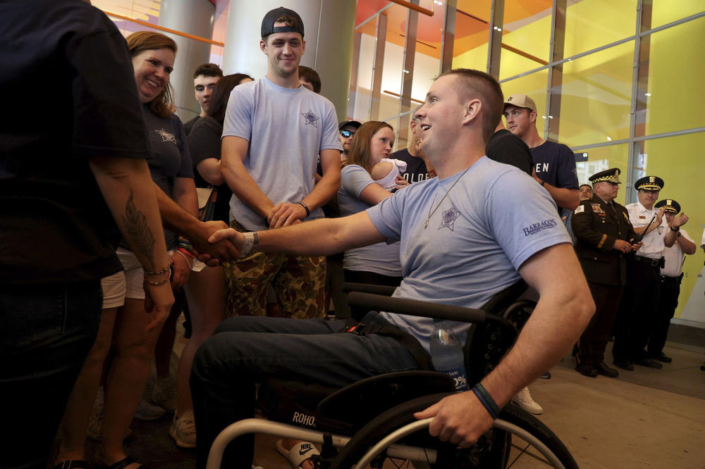 Chicago police Officer Danny Golden is released from the Shirley Ryan AbilityLab and escorted home by the Chicago Police Department on Aug. 19. Golden was paralyzed when he was shot trying to break up a fight at a neighborhood bar earlier this year.