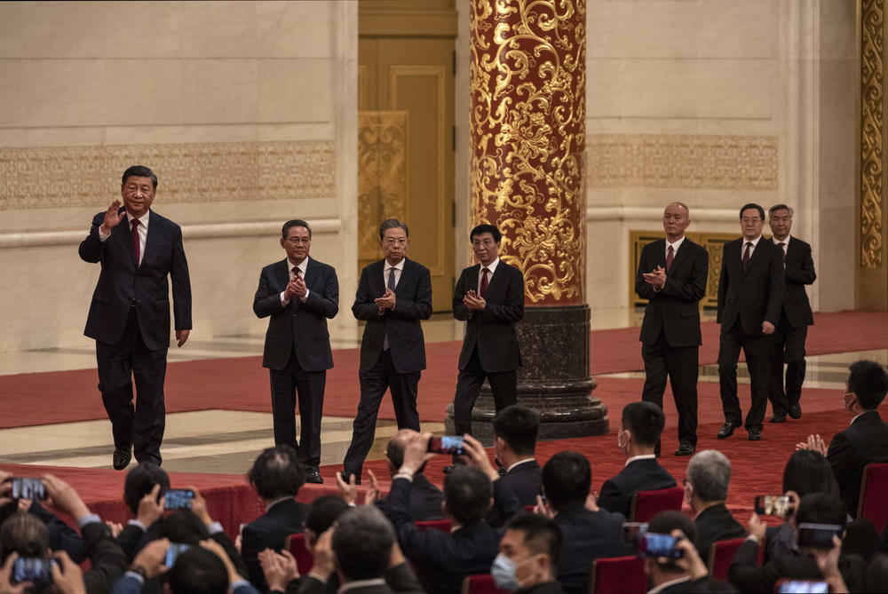 China's ruling Communist Party reveals the new Politburo Standing Committee after its 20th congress at The Great Hall of People in Beijing on Sunday. From left: Xi Jinping, Li Qiang, Zhao Leji, Wang Huning, Can Qi, Ding Xuexiang and Li Xi arrive for a group photo at a meeting with Chinese and foreign journalists.