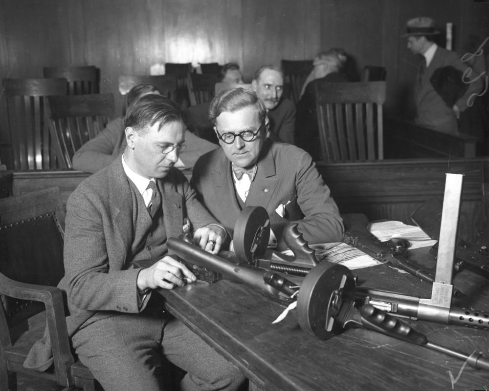 On April 19, 1929, Lt. Col. C.H. Goddard (left) and coroner Herman N. Bundesen look over machine guns believed to have been used in the St. Valentine's Day massacre, which occurred on Feb. 14, 1929, in Chicago.