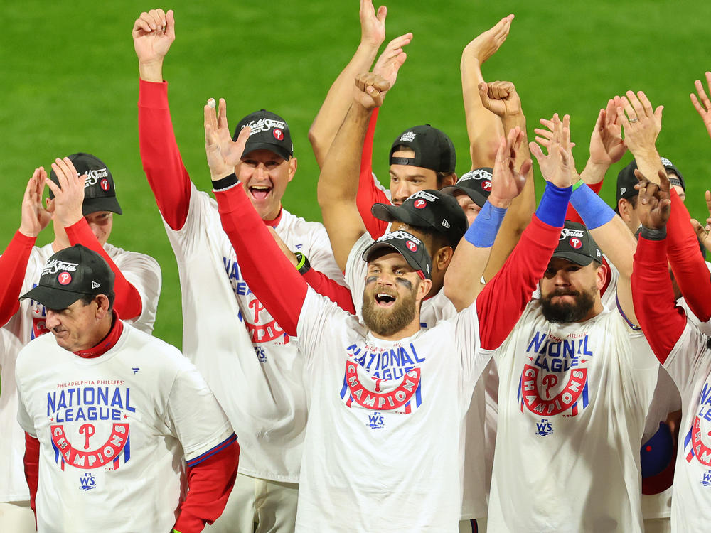Bryce Harper, center, of the Philadelphia Phillies celebrates with teammates after defeating the San Diego Padres in game five to win the National League Championship Series at Citizens Bank Park on October 23, 2022 in Philadelphia.