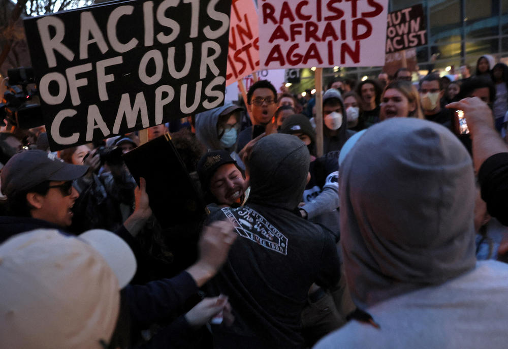 A man wearing a Proud Boys shirt fights with protesters ahead of an event featuring far-right group Proud Boys' founder Gavin McInnes at Pennsylvania State University in State College, Pa., on Monday. The event was canceled by Penn State officials, who cited 
