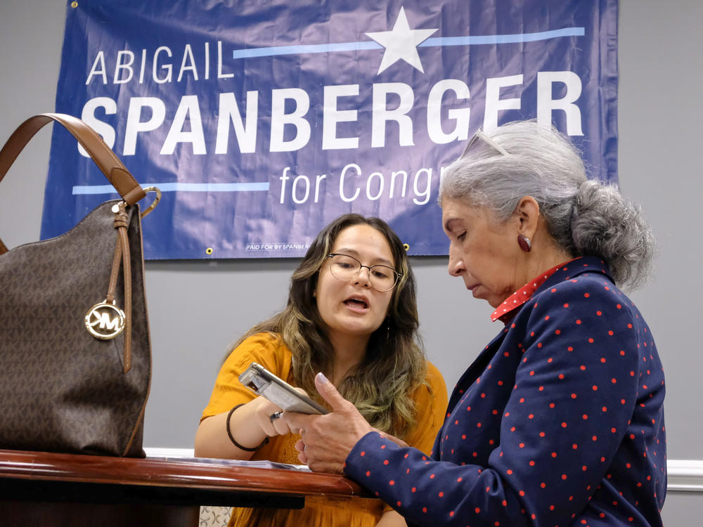 Spanberger campaign staffer Rina Murasaki guides volunteer Elane Lane through the process for knocking doors at a campaign office in Prince William County. Lane says reproductive rights is a top issue for her headed into the November election.