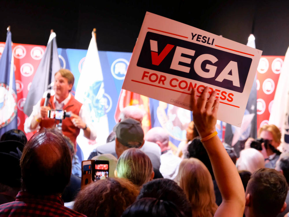 Virginia Gov. Glenn Youngkin campaigns for Republican congressional candidate Yesli Vega at a restaurant in Fredericksburg, Va. Youngkin noted Vega could make history by becoming Virginia's first Latino congressional representative.