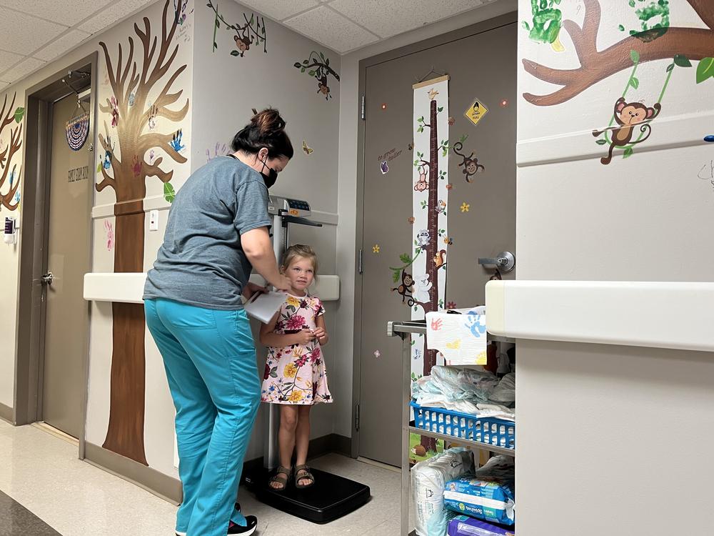 Khloe Tinker, 5, is measured ahead of an appointment at the Doniphan Family Clinic in Doniphan, Missouri. The clinic is the only source for specialized pediatric care in its rural Ozark county.