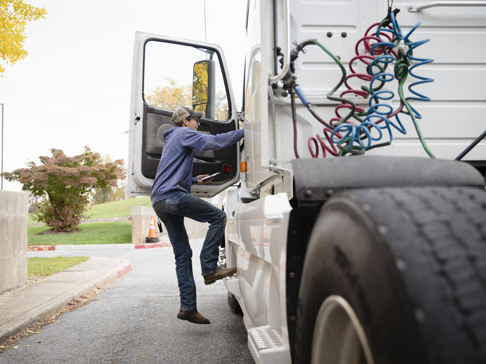 Tucker Bubacz, a 17-year-old senior, climbs into the cab of a semi truck just outside Williamsport High School in Williamsport, Md. on Monday, Oct. 17, 2022.