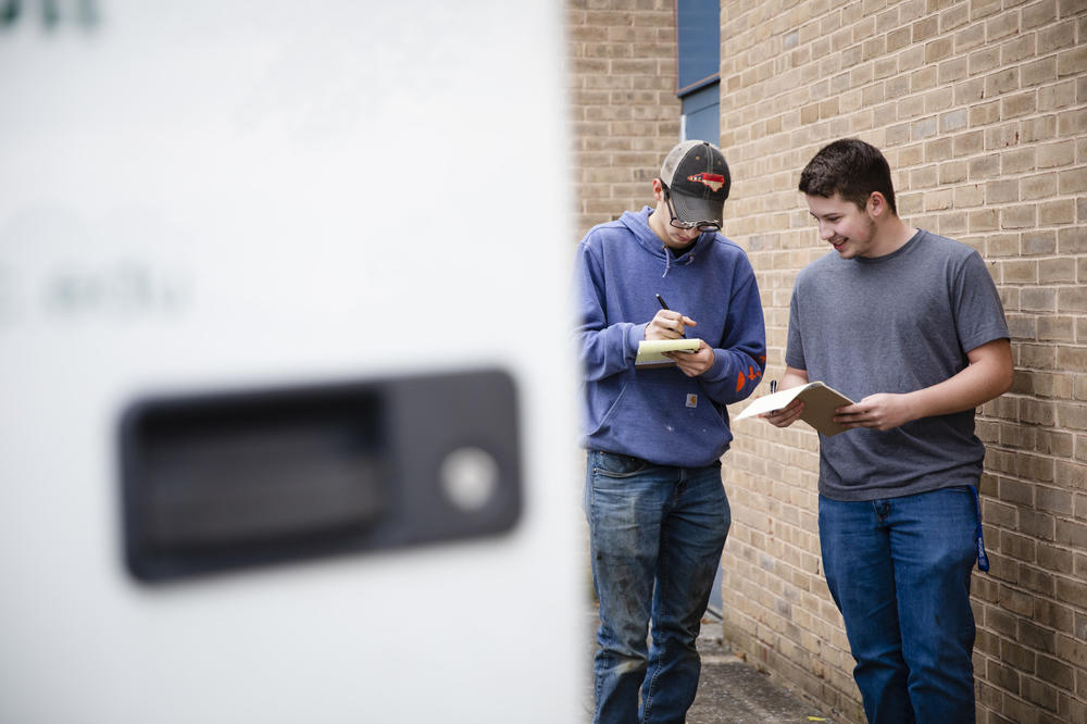 Tucker Bubacz and Joshua Hewitt fill out their pre-trip inspection sheets outside Williamsport High School in Williamsport, Md., on Monday, Oct. 17, 2022.