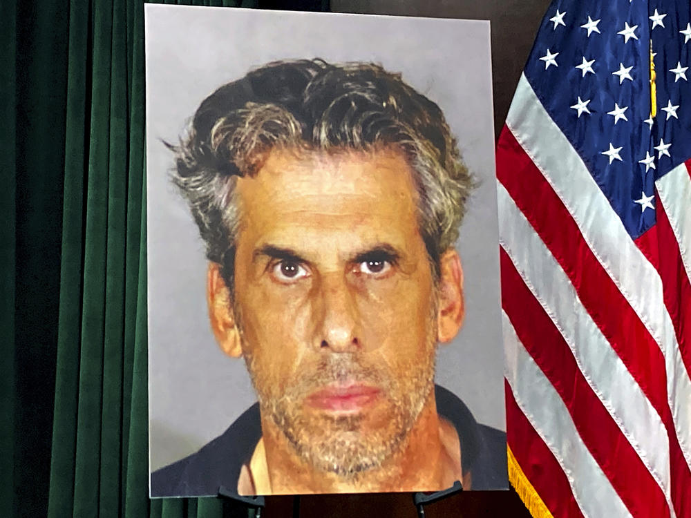 A photo of TV producer Eric Weinberg is displayed before a news conference to announce sexual assault charges against Weinberg earlier this year.