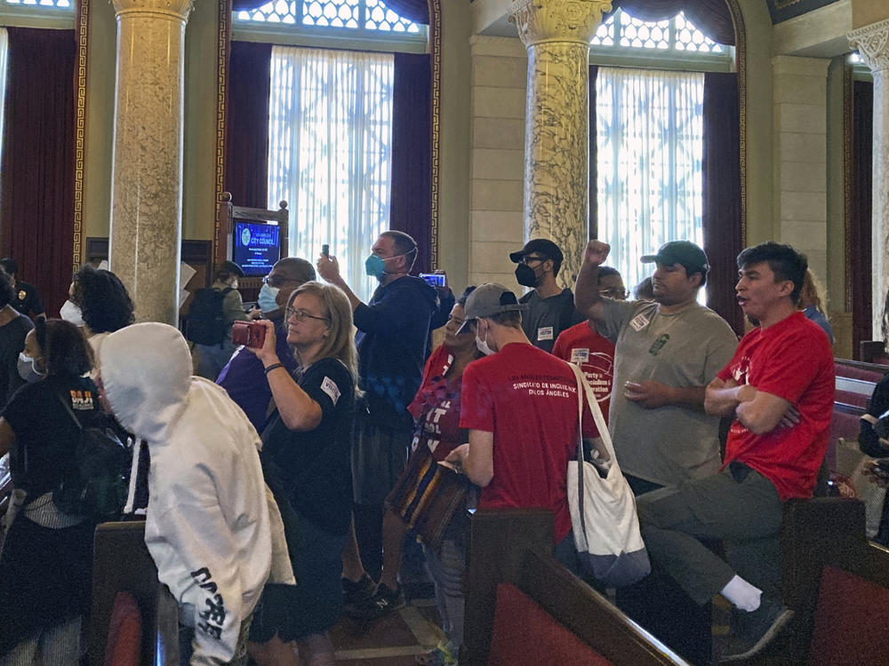 Protesters walk away after disrupting a Los Angeles City Council meeting demanding the resignations of council members, Kevin de Leon and Gil Cedillo in Los Angeles, Wednesday, Oct. 26, 2022.