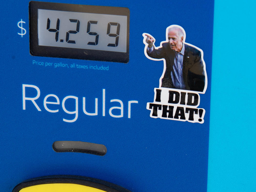 A gas pump displays current fuel prices, along with a sticker of President Biden, at a gas station in Arlington, Va., on March 16. The sticker says 