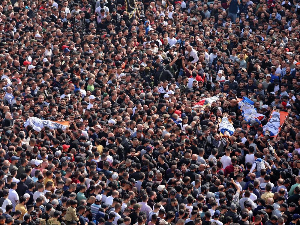 Mourners attend the funeral of Palestinians killed in an overnight Israeli raid in the occupied West Bank city of Nablus on Tuesday. The Israeli army said it was targeting an emerging armed group called Lions' Den.