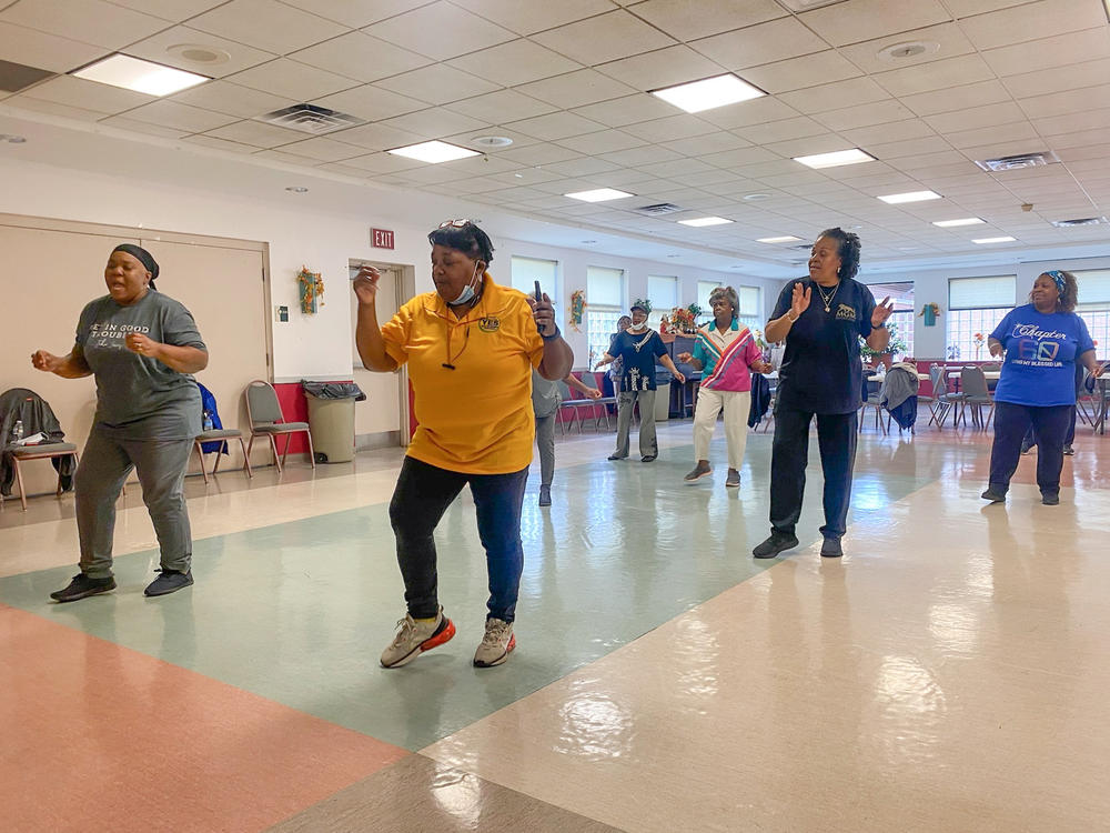 At the Lawton Street Community Center in Akron, Ohio, Francine Blake leads a line dancing class for senior citizens. The women in this class will help determine the outcome of a competitive race in Ohio's 13th Congressional District.