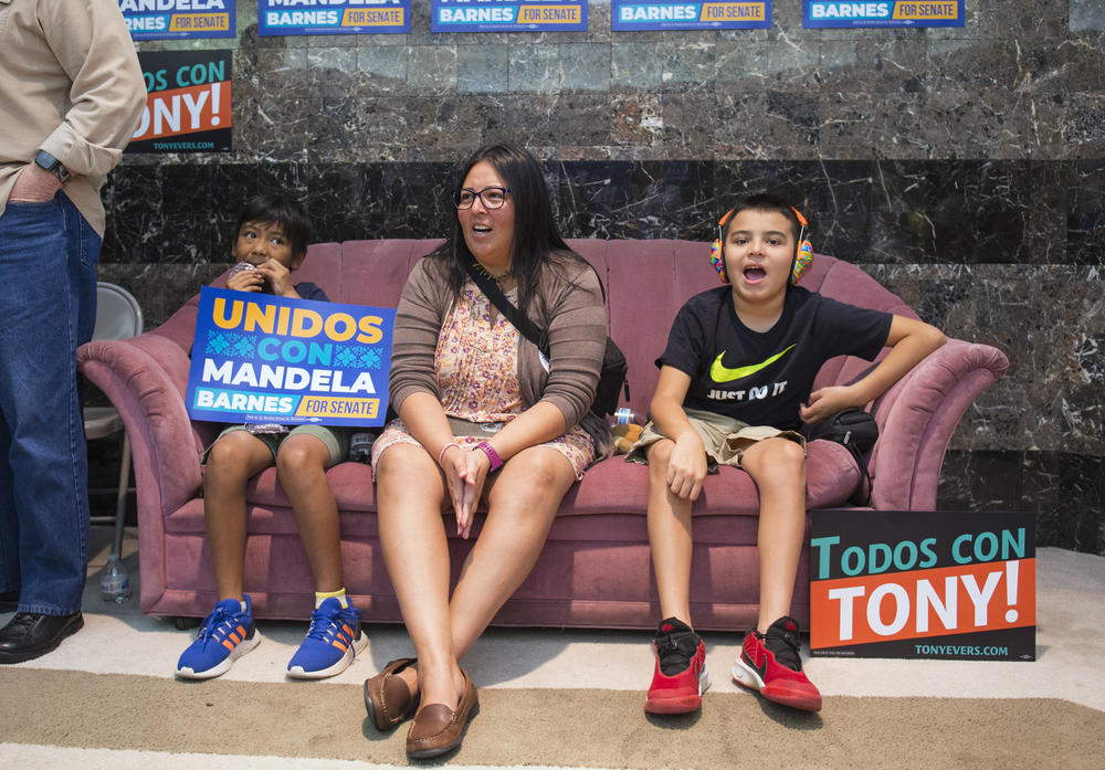 Daysi JimÃ©nez (center) and her sons (from left) Ben and Christopher cheer for U.S. Senate candidate Mandela Barnes as he gives a speech at a Latinos for Mandela event at the Milwaukee Democratic Party office in Milwaukee on Saturday.