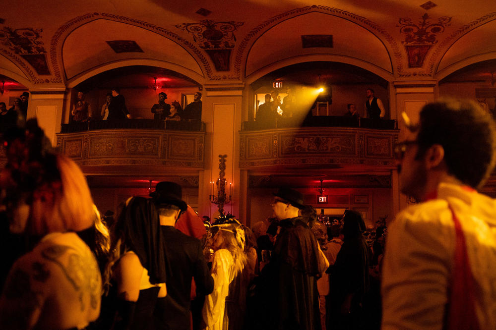 People watch the crowd and a variety of performers at Theatre Bizarre.