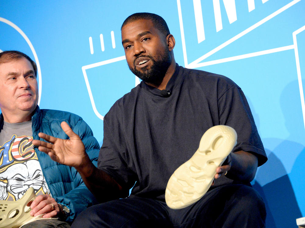 Steven Smith and Kanye West speak on stage at the 