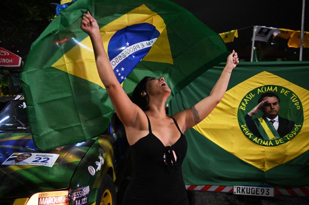 A supporter of Brazilian President Jair Bolsonaro reacts as she watches the vote count of the first-round election in Rio de Janeiro on Oct. 2.