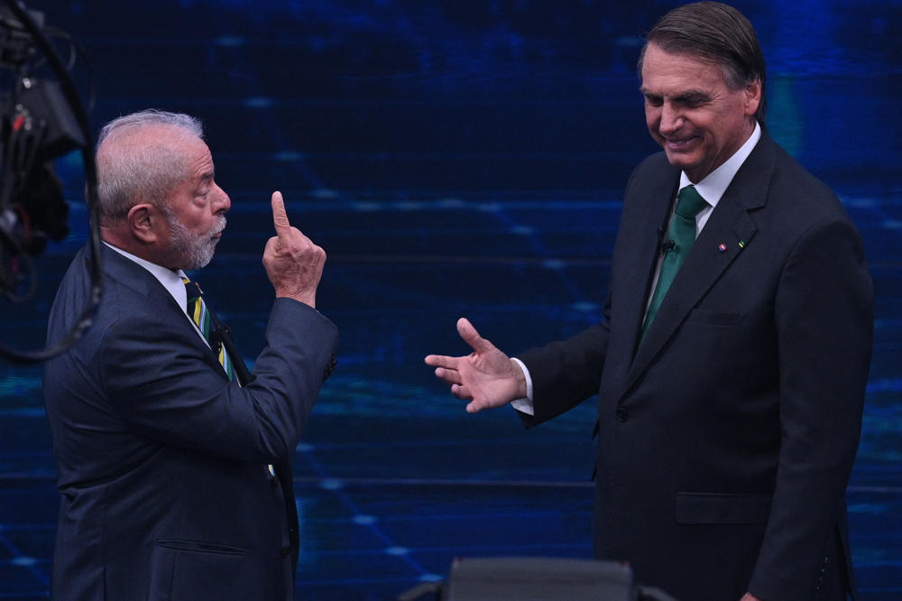 Brazil's former President Luiz Inácio Lula da Silva (left) and Brazilian President Jair Bolsonaro gesture during a televised presidential debate in São Paulo on Oct. 16.